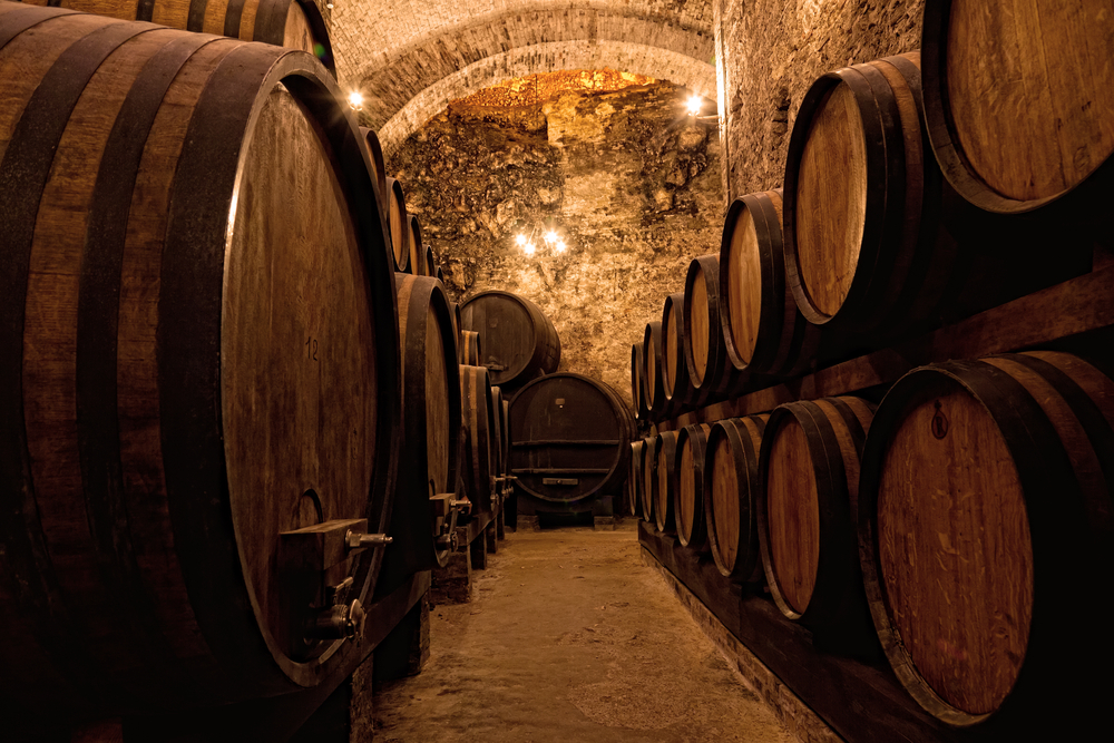 Wooden barrels with wine in a wine vault, Italy.